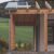 Terrassenüberdachung aus Holz mit Glaseindeckung und Dachrinne an einem Einfamilienhaus im Waldviertel